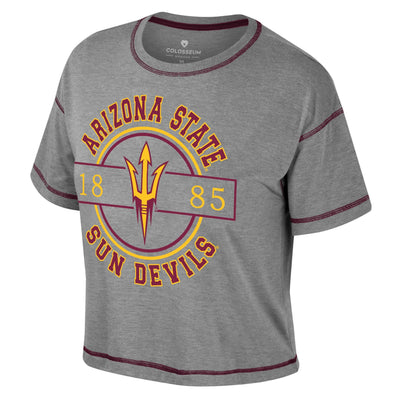 ASU grey crop top with maroon stitching along the trim. there is the text "Arizona State sun Devils" in maroon outlined in gold that is surounding a gold and maroon circle outline. within the circle is a pitchfork in gold outlined in maroon. There is also a maroon outline of a rectangle that cuts through the circle that has the numbers 1885.
