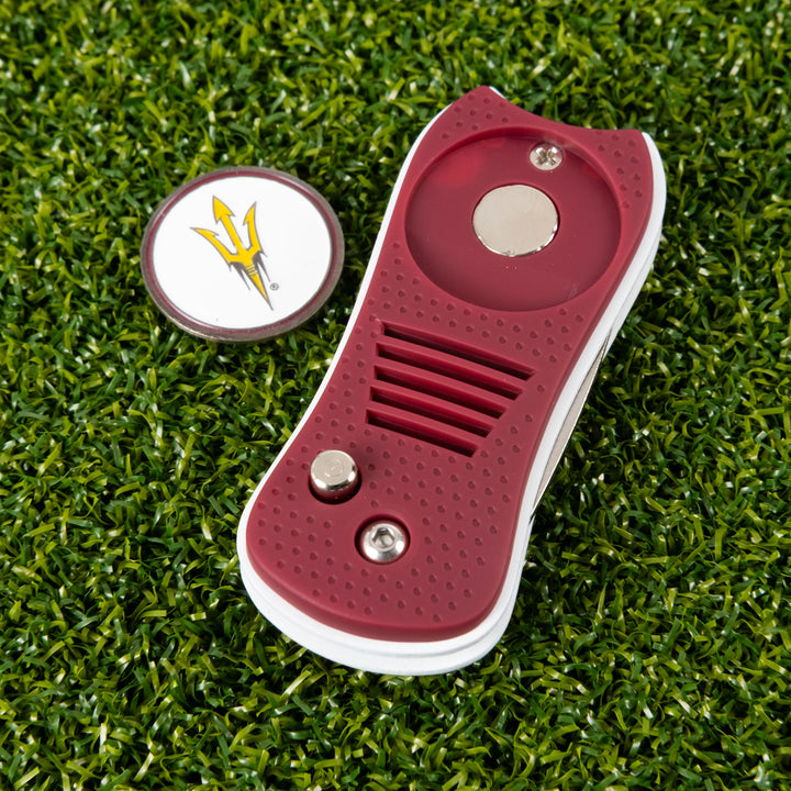 divot tool and ball marker on grass