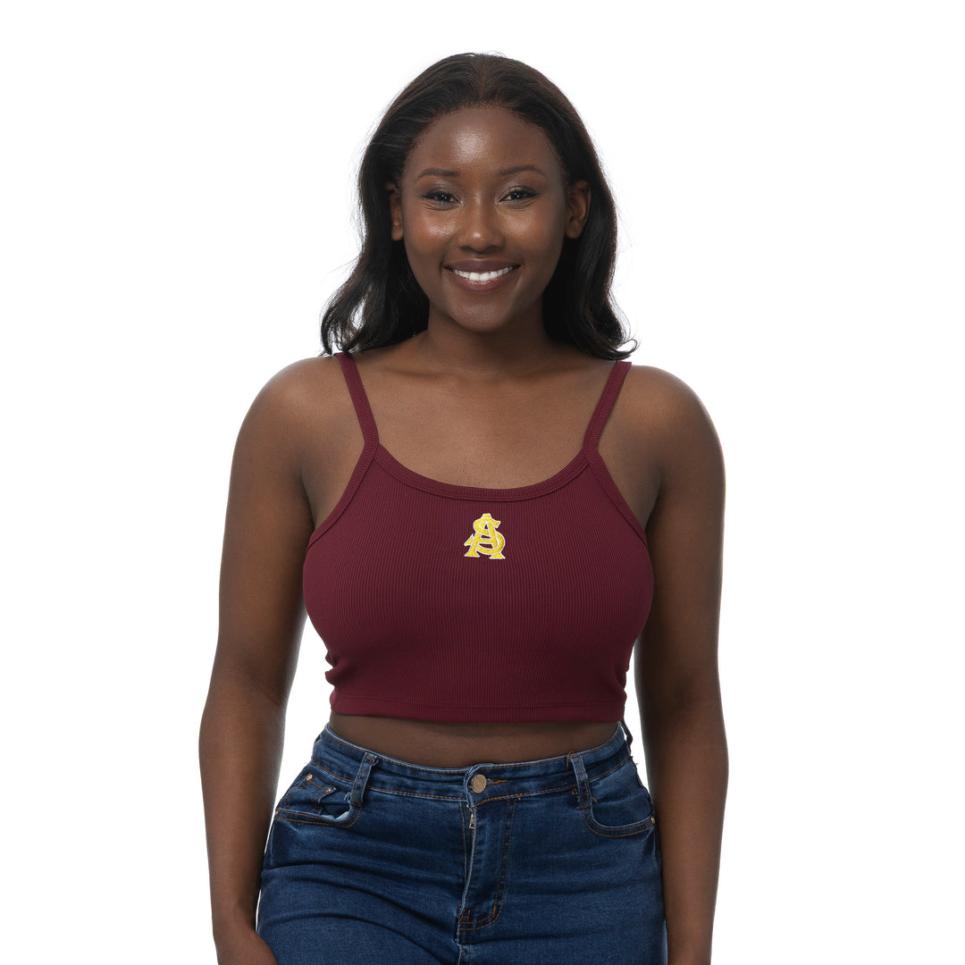 Woman wearing a maroon tank top with an interlocking A&S logo on a white background