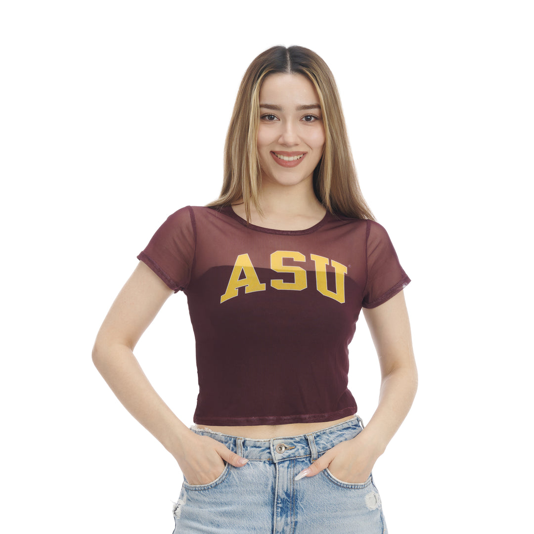 A woman modeling a maroon short-sleeve crop top with a sheer mesh overlay and 'ASU' printed in yellow across the chest, paired with light-wash blue jeans against a plain white background.