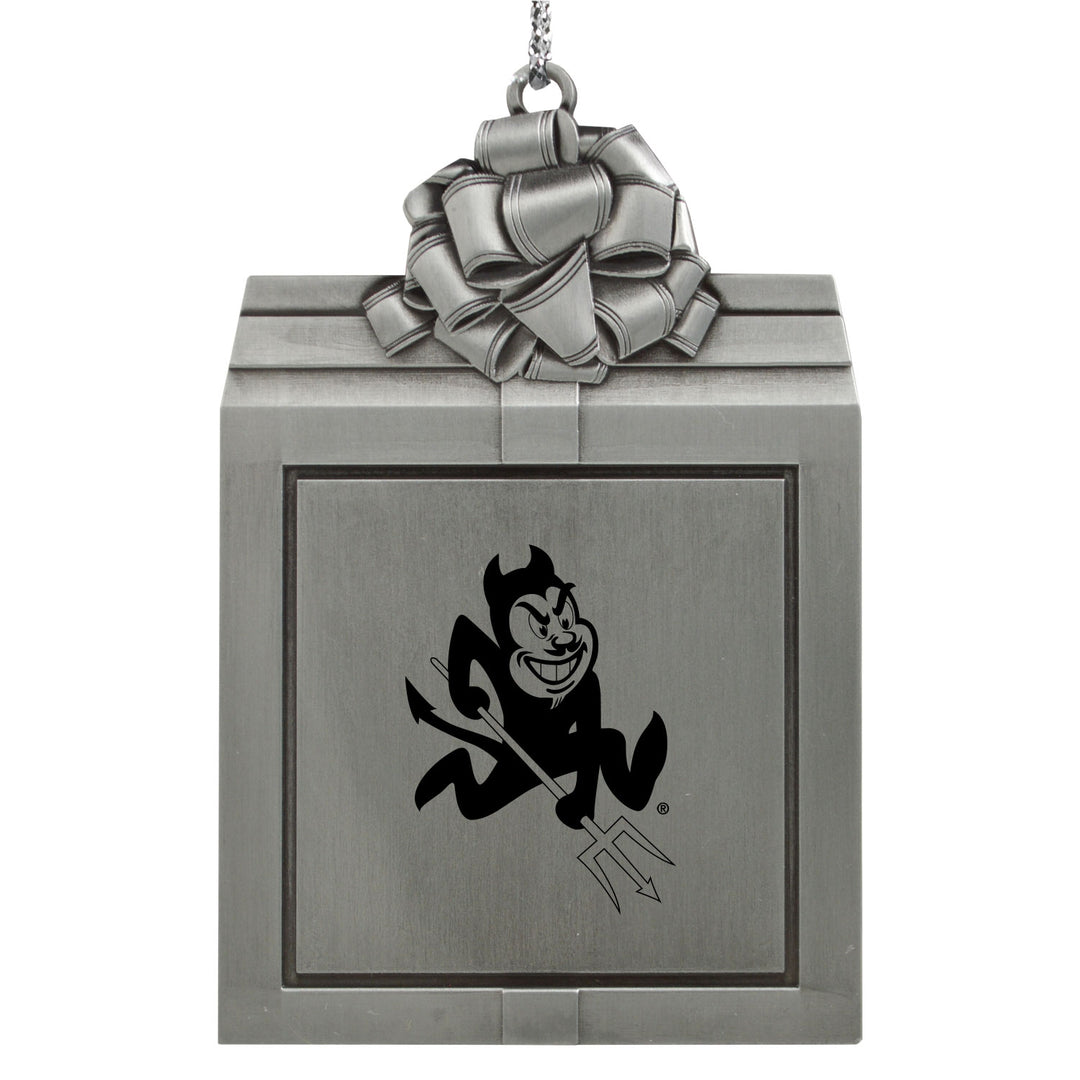 Metallic gift box ornament with a cartoon devil design and bow on top.
