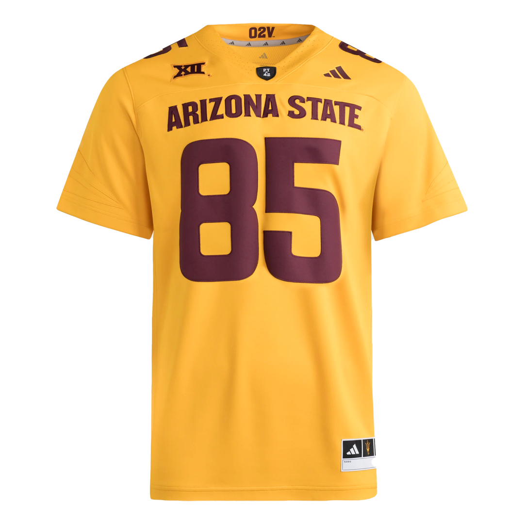 Gold football jersey with Big12 patch embroidered on the right front shoulder and Adidas logo on the left front shoulder. PT42 patch on the front of the collar. #85 on the front and top shoulders in maroon.