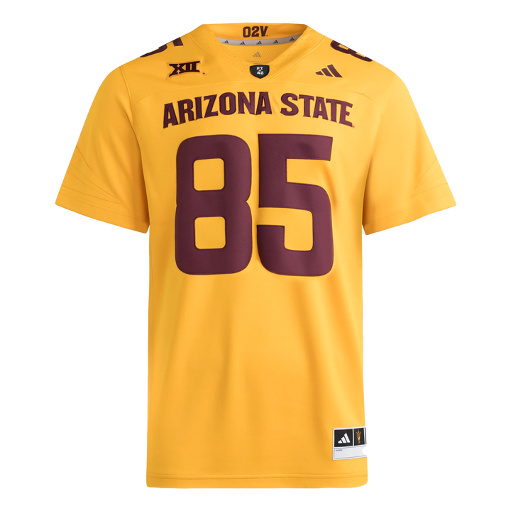 Gold football jersey with Big12 patch embroidered on the right front shoulder and Adidas logo on the left front shoulder. PT42 patch on the front of the collar. #85 on the front and top shoulders in maroon.