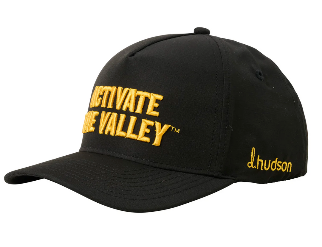 Black cap with yellow text and branding on a white background