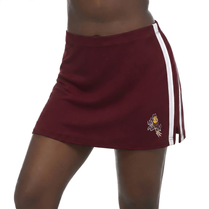 A maroon athletic mini skirt with white side stripes and a Sparky logo, shown on a model against a white background.