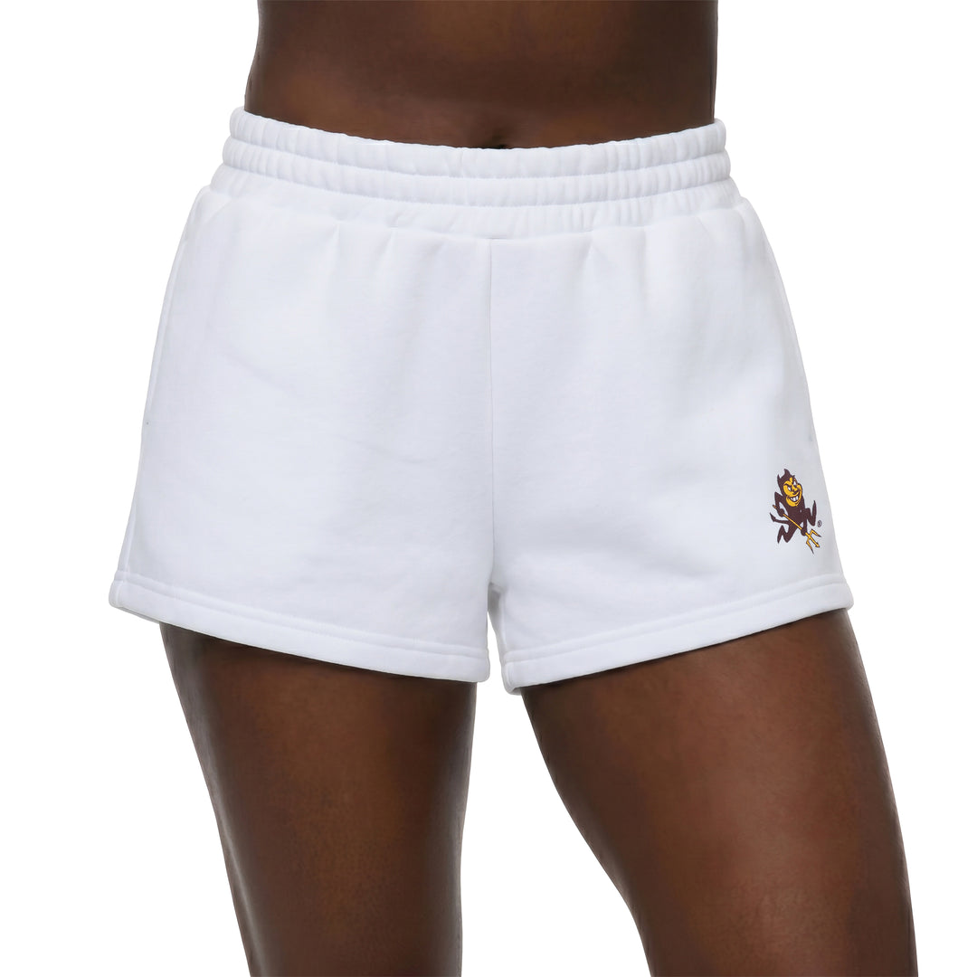 White athletic shorts with an elastic waistband, featuring a small embroidered mascot logo on the lower left leg, shown on a model against a white background.