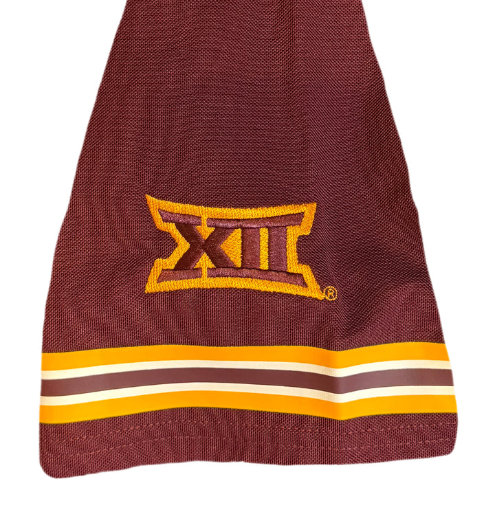 Maroon sleeve with 12 in roman numerals patch in maroon and gold above maroon, gold and white stripes lining the hem