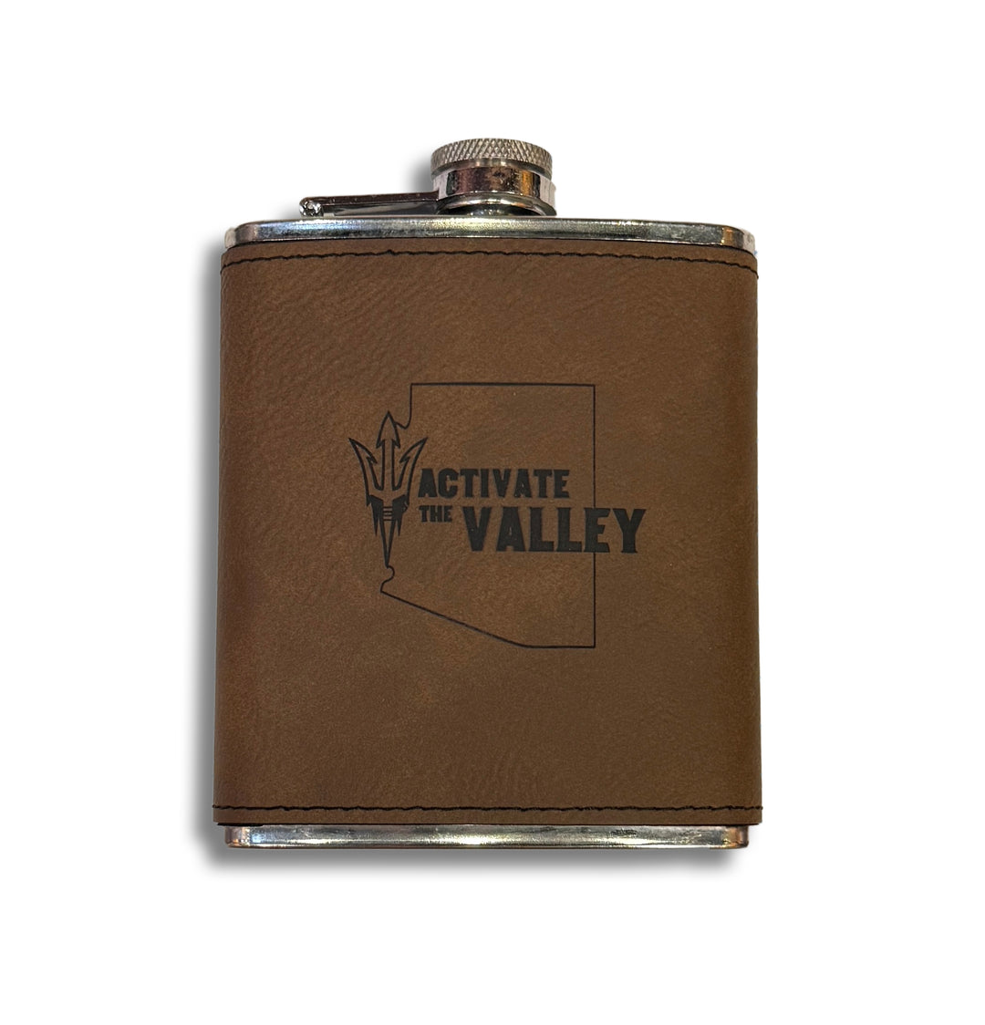 Metal flask with brown leather cover and 'Activate the Valley' in black with black outline of the state of Arizona.