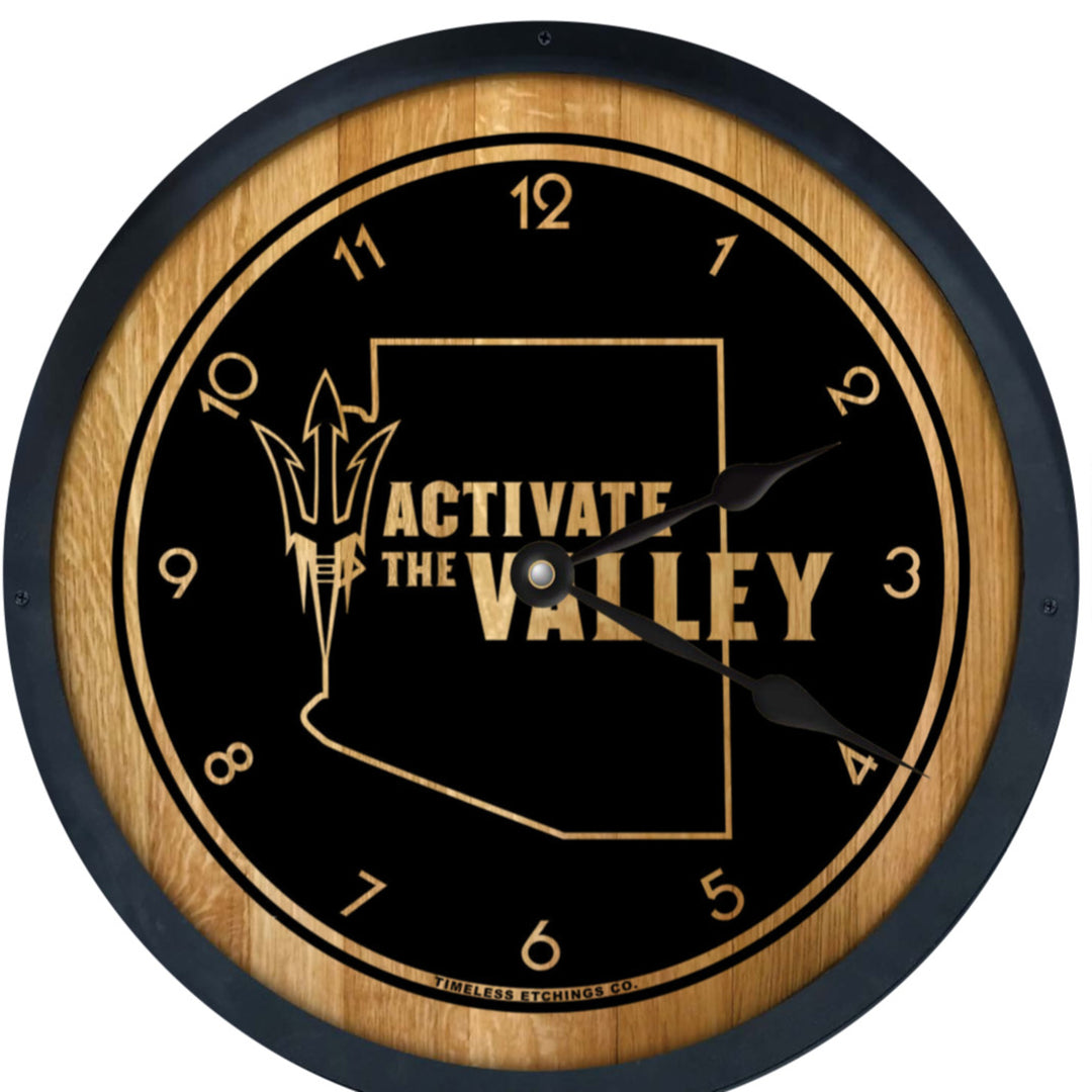 Wooden barrel style clock framed in dark metal with clock face burned into wood, leaving the number and 'Activate the Valley' and an outline of the state of Arizona.