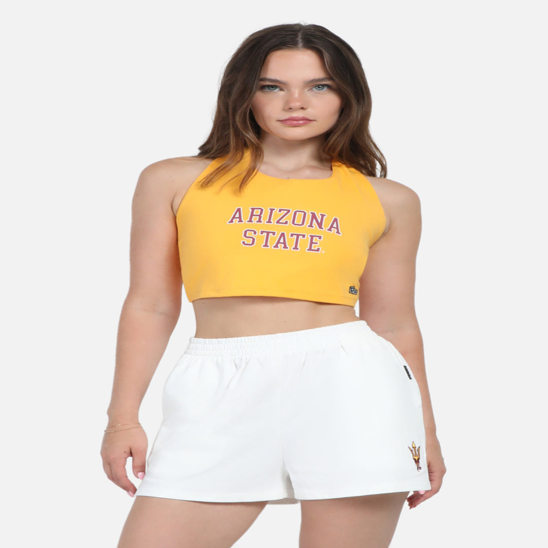 Model wearing cropped ASU halter top in gold. 