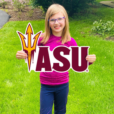 Girl holding lawn sign in grass with pitchfork and 'ASU' lettering