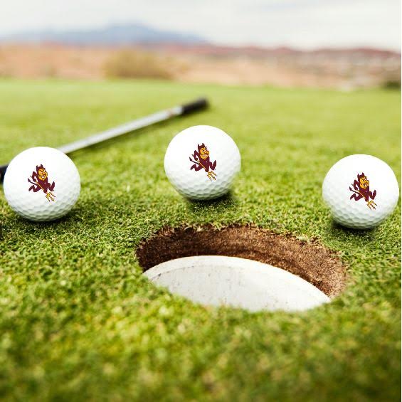 ASU 3 white golf balls with Sparky around golf hole in grass