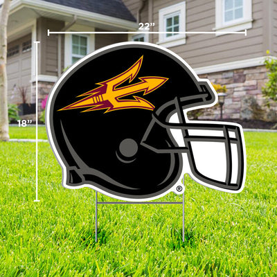 ASU football helmet lawn sign in black with gold sideways pitchfork outline across the side, in front yard