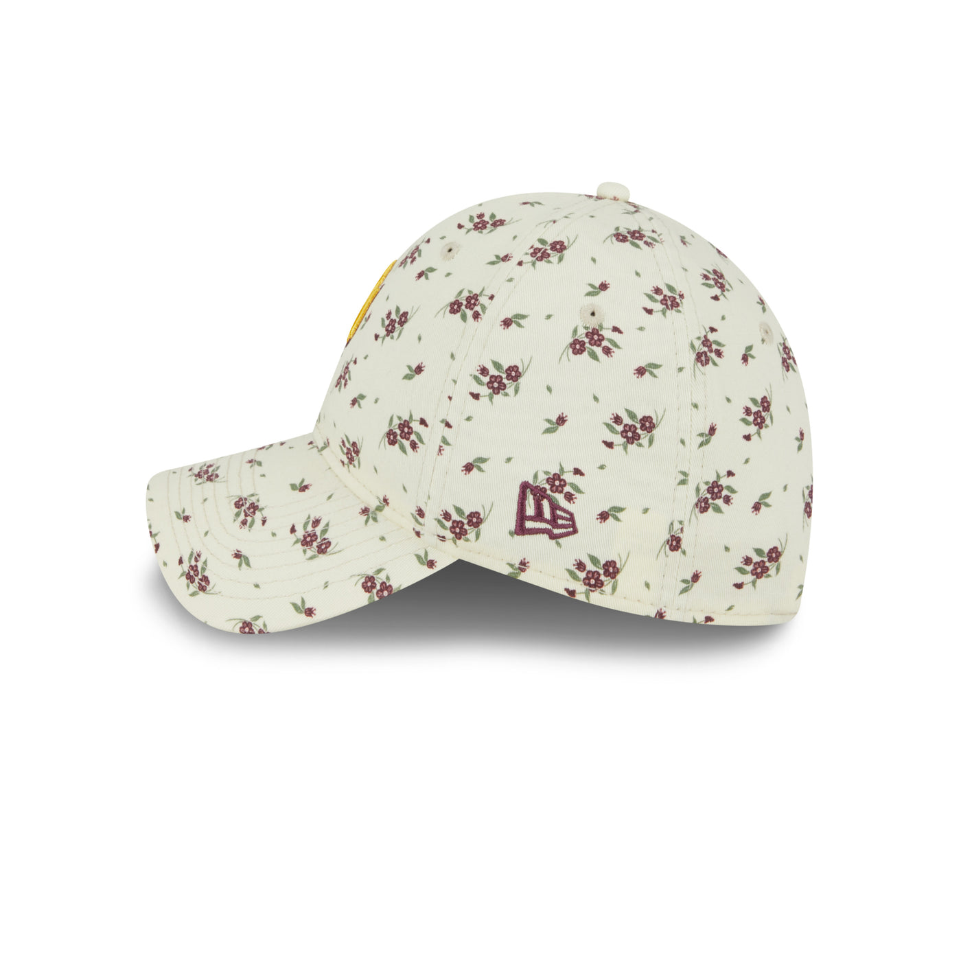 Side view of cream colored flower patterned hat. Has the new era logo on the side in maroon.