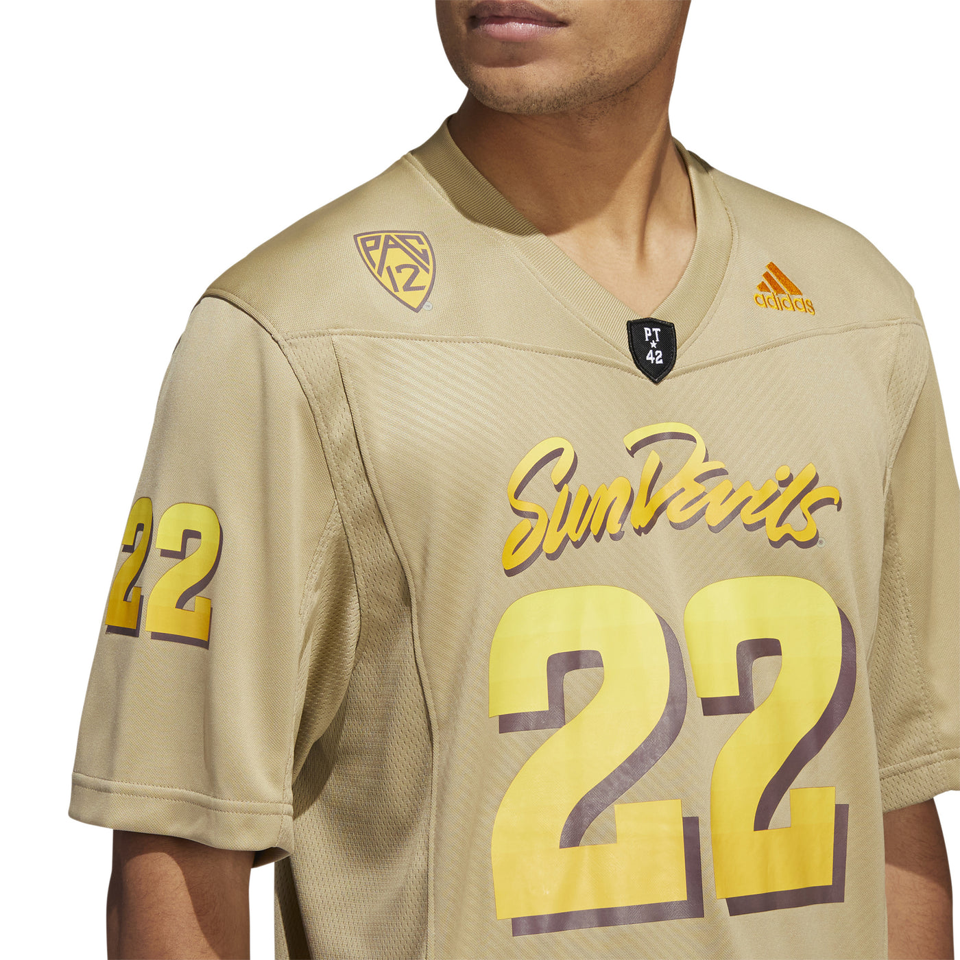 ASU tan football jersey on model. Chest close up with PAC 12 and ADIDAS logo on the collarbone.
