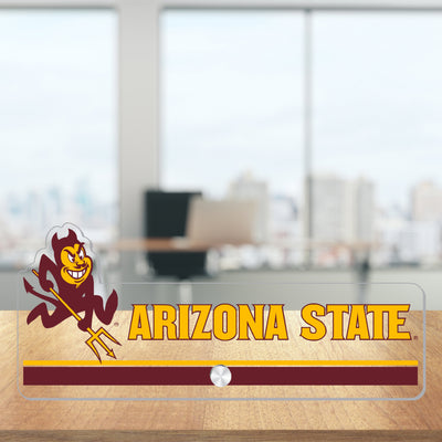 A clear sign with Sparky and "Arizona State" spelled out in gold across. The sign is on a desk.