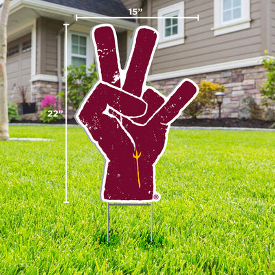 ASU lawn sign in front yard of maroon hand with a gold pitchfork on the wrist making the 'pitchfork' sign 