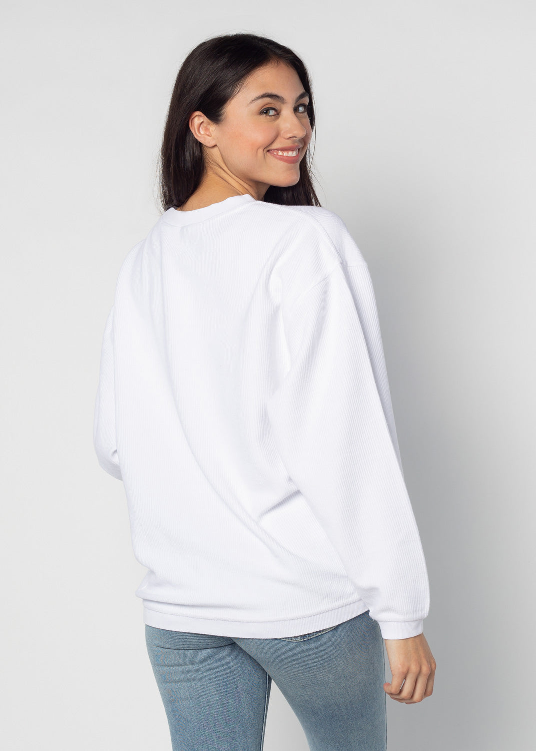 Back view of woman wearing a white corded crew