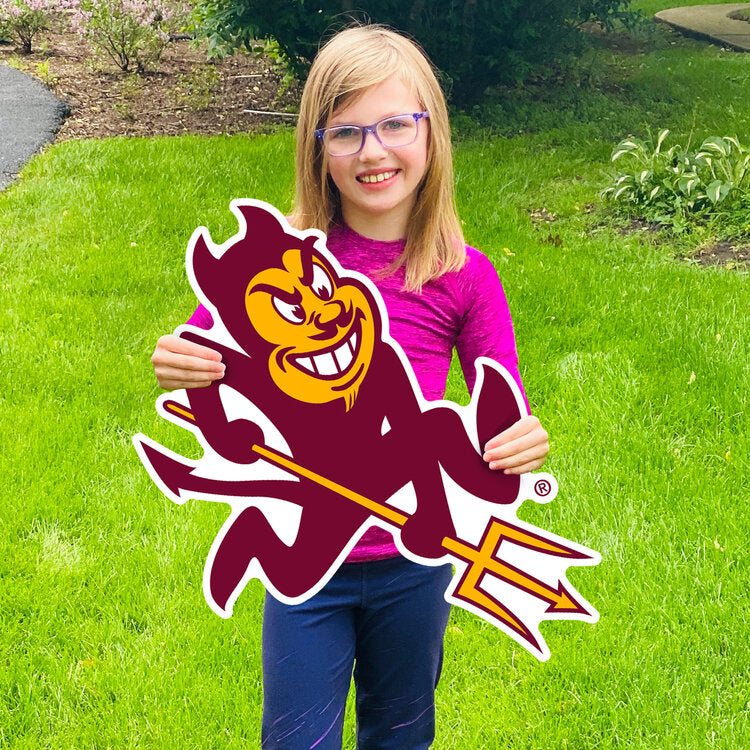 Girl holding ASU lawn sign in grass of Sparky
