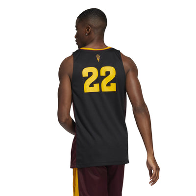 Back view of model wearing ASU black Adidas basketball jersey with '22' below a pitchfork and gold features